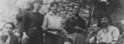 1942. The Psiloritis Mountains hideout with Manolis Bandouvas, center foreground with cigarette. George Doundoulakis, far left. Patrick Leigh Fermor with cigarette standing behind Bandouvas. John Androulakis, standing next to George with black "mandili" or headscarf. Bandouvas' bodyguards on right.