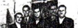April, 1944. The organizers of the Salonica "cell" with team members standing behind the wireless radio, in the Jewish textile factory. Left to right: Nicos Oreopoulos, Cosmas Yiapitzoglou, Helias Doundoulakis, and the guards, Nikitas and Stavros.